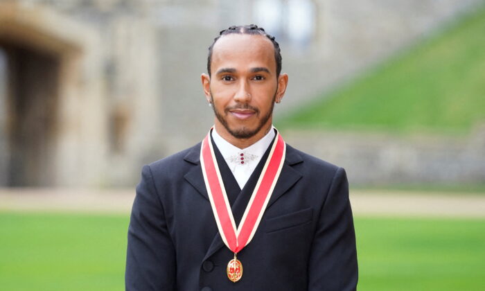 Lewis Hamilton poses for a photo after he was made a Knight Bachelor during an investiture ceremony at Windsor Castle in Windsor, Britain, on Dec. 15, 2021. (Andrew Matthews/Pool via Reuters)
