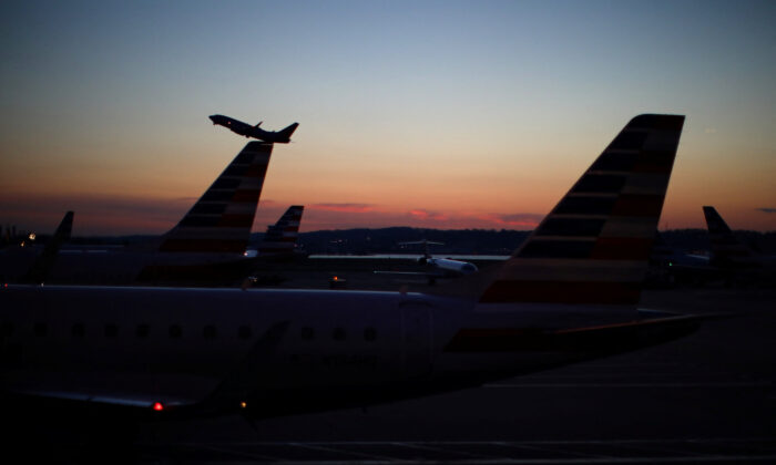 An airplane takes off from the Ronald Reagan National Airport in Wash., on March 18, 2020. (Carlos Barria/Reuters)