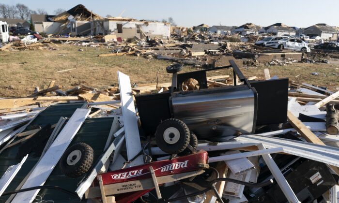 A Radio Flyer wagon lies among debris, after a tornado touched down, along Moss Creek Avenue, in Bowling Green, Ky., on Dec. 14, 2021. (James Kenney/AP Photo)