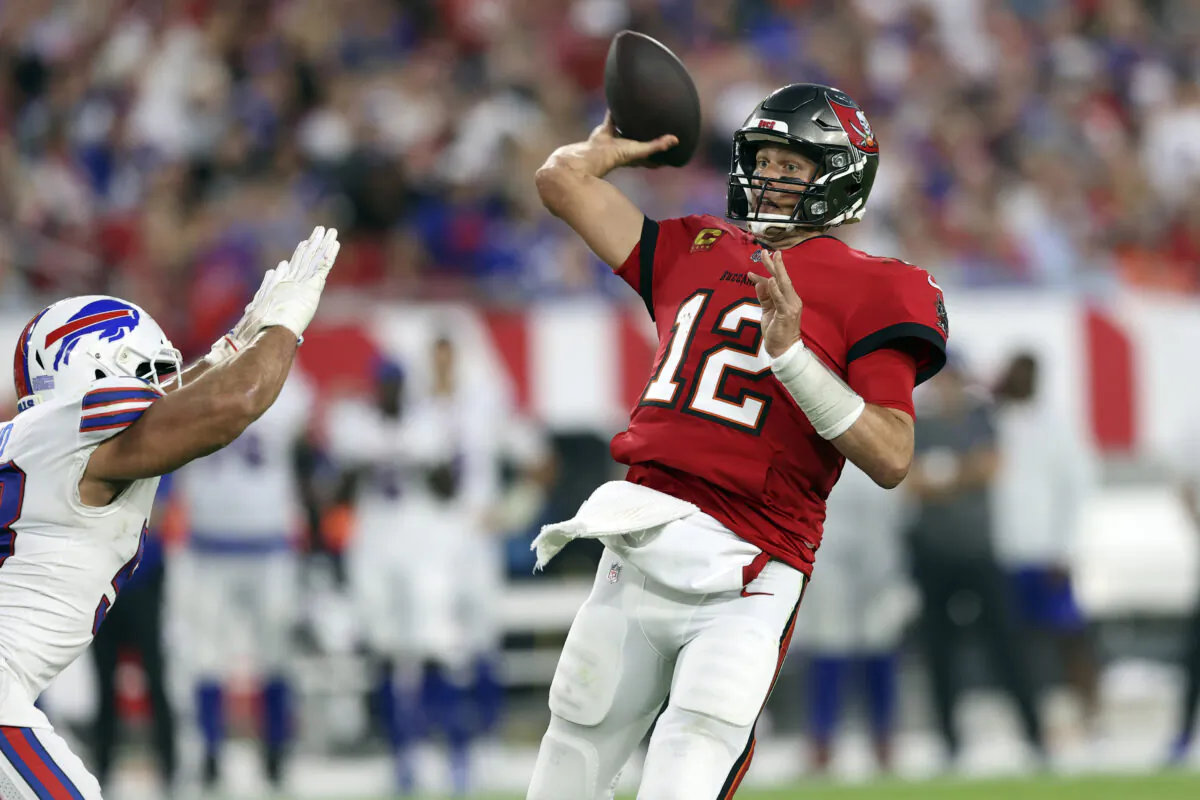 Tampa Bay Buccaneers quarterback Tom Brady (12) throws a pass to wide receiver Mike Evans during the first half of an NFL football game against the Buffalo Bills in Tampa, Fla., on Dec. 12, 2021. (Mark LoMoglio/AP Photo)   