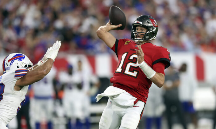 Tampa Bay Buccaneers quarterback Tom Brady (12) throws a pass to wide receiver Mike Evans during the first half of an NFL football game against the Buffalo Bills in Tampa, Fla., on Dec. 12, 2021. (Mark LoMoglio/AP Photo)   