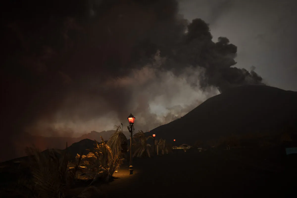 Ash covers the streets and houses in Las Manchas village as lava flows from the volcano, on the Canary island of La Palma, Spain, on Dec. 6, 2021. (Emilio Morenatti/AP Photo)