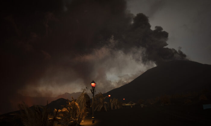 Ash covers the streets and houses in Las Manchas village as lava flows from the volcano, on the Canary island of La Palma, Spain, on Dec. 6, 2021. (Emilio Morenatti/AP Photo)