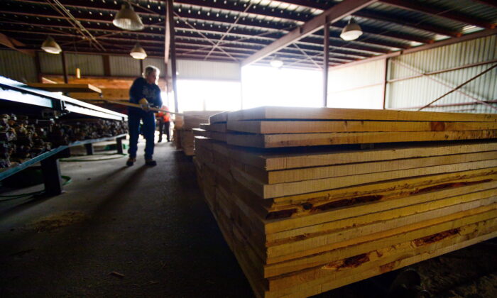 Workers sort softwood in a workshop in Madawaska, Ont., on April 25, 2017. (The Canadian Press/Sean Kilpatrick)