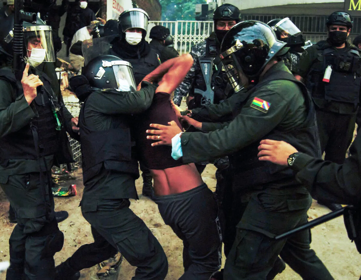 Police in Santa Cruz arrest one of the rioters outside the farmer's union office on Dec. 13, 2021. (Cesar Calani/The Epoch Times)