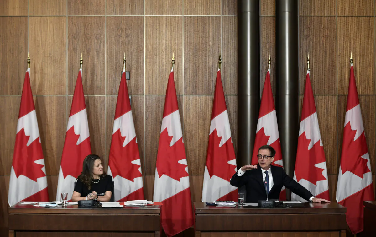 Deputy Prime Minister and Finance Minister Chrystia Freeland listens as the Bank of Canada Governor Tiff Macklem speaks during a joint news conference in Ottawa on Dec. 13, 2021. (The Canadian Press/Justin Tang)