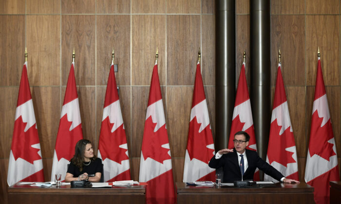Deputy Prime Minister and Finance Minister Chrystia Freeland listens as the Bank of Canada Governor Tiff Macklem speaks during a joint news conference in Ottawa on Dec. 13, 2021. (The Canadian Press/Justin Tang)