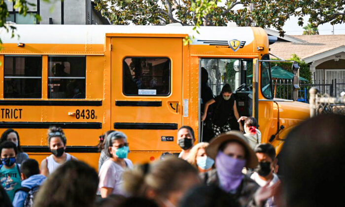Students and parents arrive masked for the first day of the school year at Grant Elementary School in Los Angeles on Aug. 16, 2021. (Robyn Beck/AFP via Getty Images)