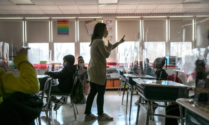 A third-grade teacher talks with students about their pandemic-related fears on the first day of in-person learning for five days per week at Stark Elementary School in Stamford, Conn., on March 10, 2021. (John Moore/Getty Images)