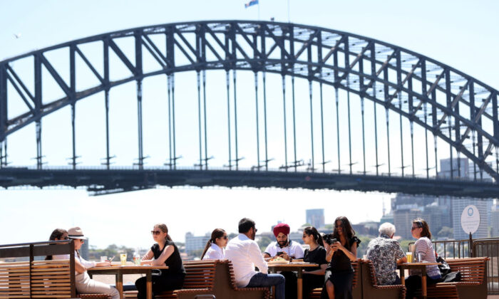 People dine outdoors at Opera House Bar in Sydney, Australia, on Oct. 18, 2021. (Brendon Thorne/Getty Images)