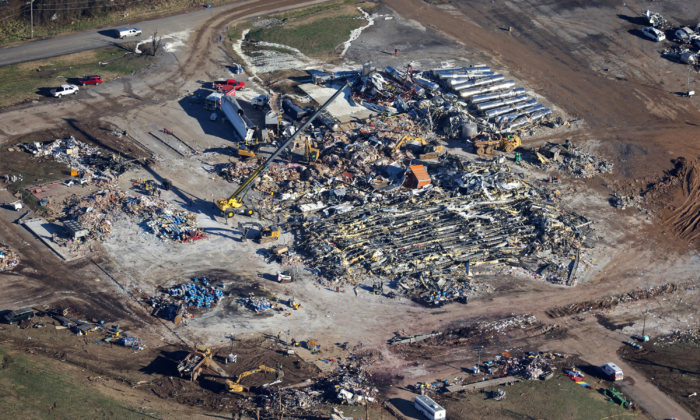 MAYFIELD, KENTUCKY - DECEMBER 13: In this aerial view, crews clear the rubble at the Mayfield Consumer Products candle factory after it was destroyed by a tornado three days prior, on December 13, 2021 in Mayfield, Kentucky. Multiple tornadoes struck several Midwest states in the late evening on December 10, causing widespread destruction and multiple fatalities.   (Photo by Scott Olson/Getty Images)