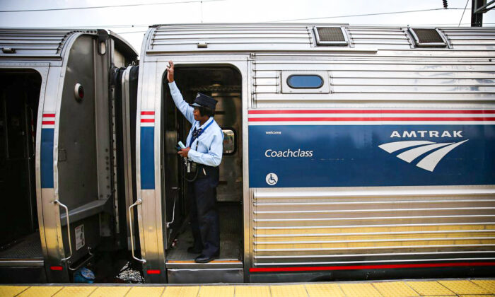 A train conductor signals from an Amtrak train September 3, 2015 in New Carrollton, Maryland. U.S. (Alex Wong/Getty Images)