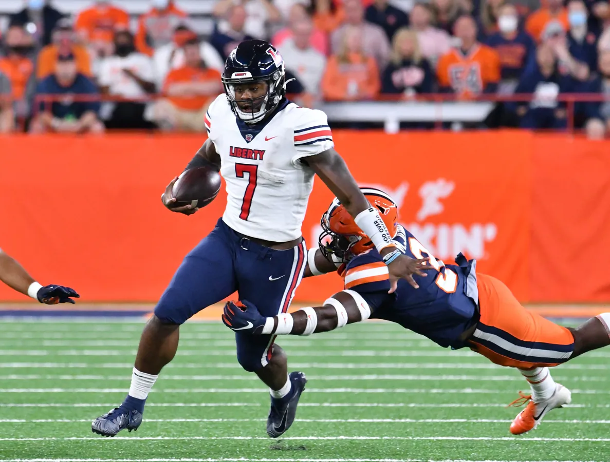 Liberty Flames quarterback Malik Willis (7) escapes a tackle by Syracuse Orange linebacker Mikel Jones (3) in the first quarter at the Carrier Dome, in Syracuse, N.Y., on Sep 24, 2021, (Mark Konezny/USA TODAY Sports via Field Level Media)