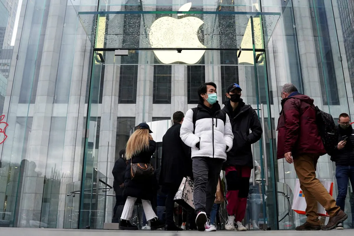People leave the Apple Store on Fifth Avenue on Black Friday, in the Manhattan borough of New York on Nov. 26, 2021. (Carlo Allegri/Reuters)