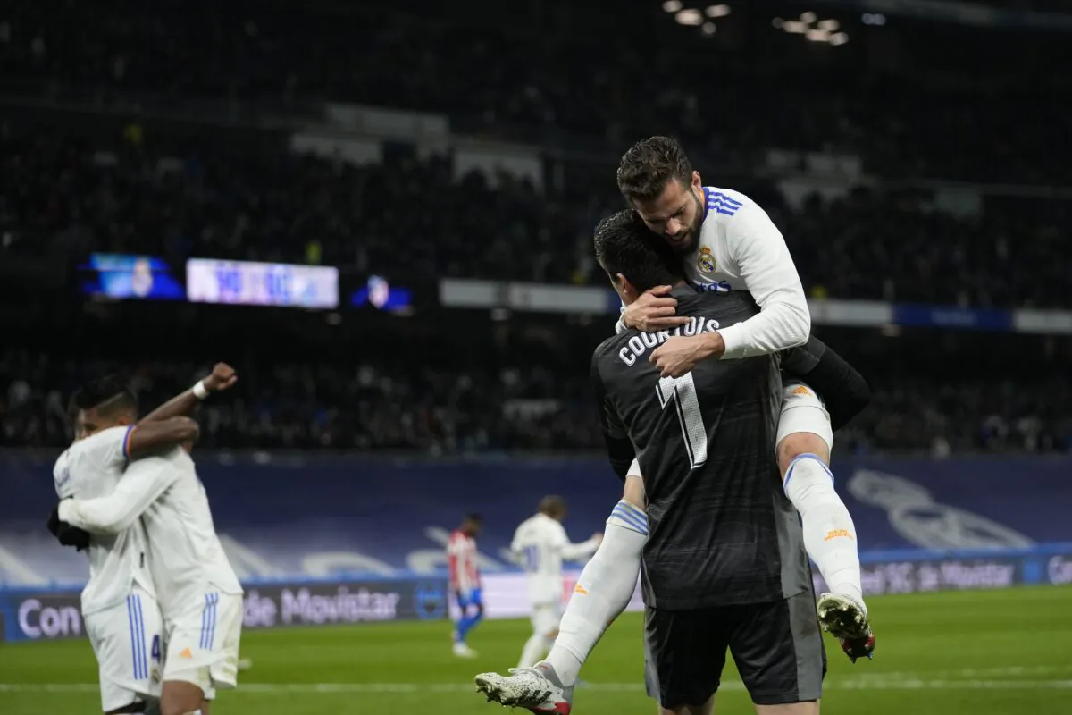 Real Madrid's team players celebrate as they won the Spanish La Liga soccer match between Real Madrid and Atletico Madrid, at Santiago Bernabeu stadium in Madrid, Spain, on Dec. 12, 2021. (Bernat Armangue/AP Photo)
