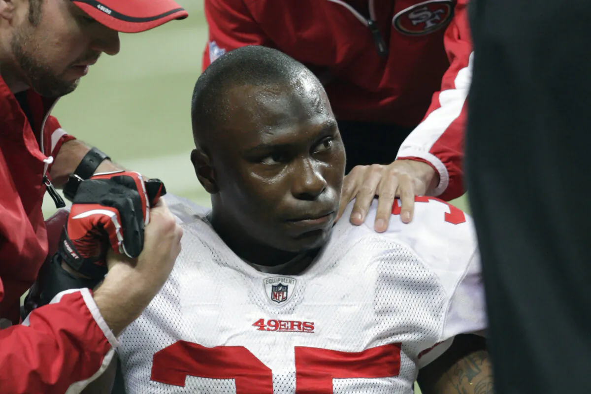 San Francisco 49ers cornerback Phillip Adams (35) is attended to after injuring his left leg during the third quarter of an NFL football game against the St. Louis Rams in St. Louis on Dec. 26, 2010. (Tom Gannam/AP Photo)