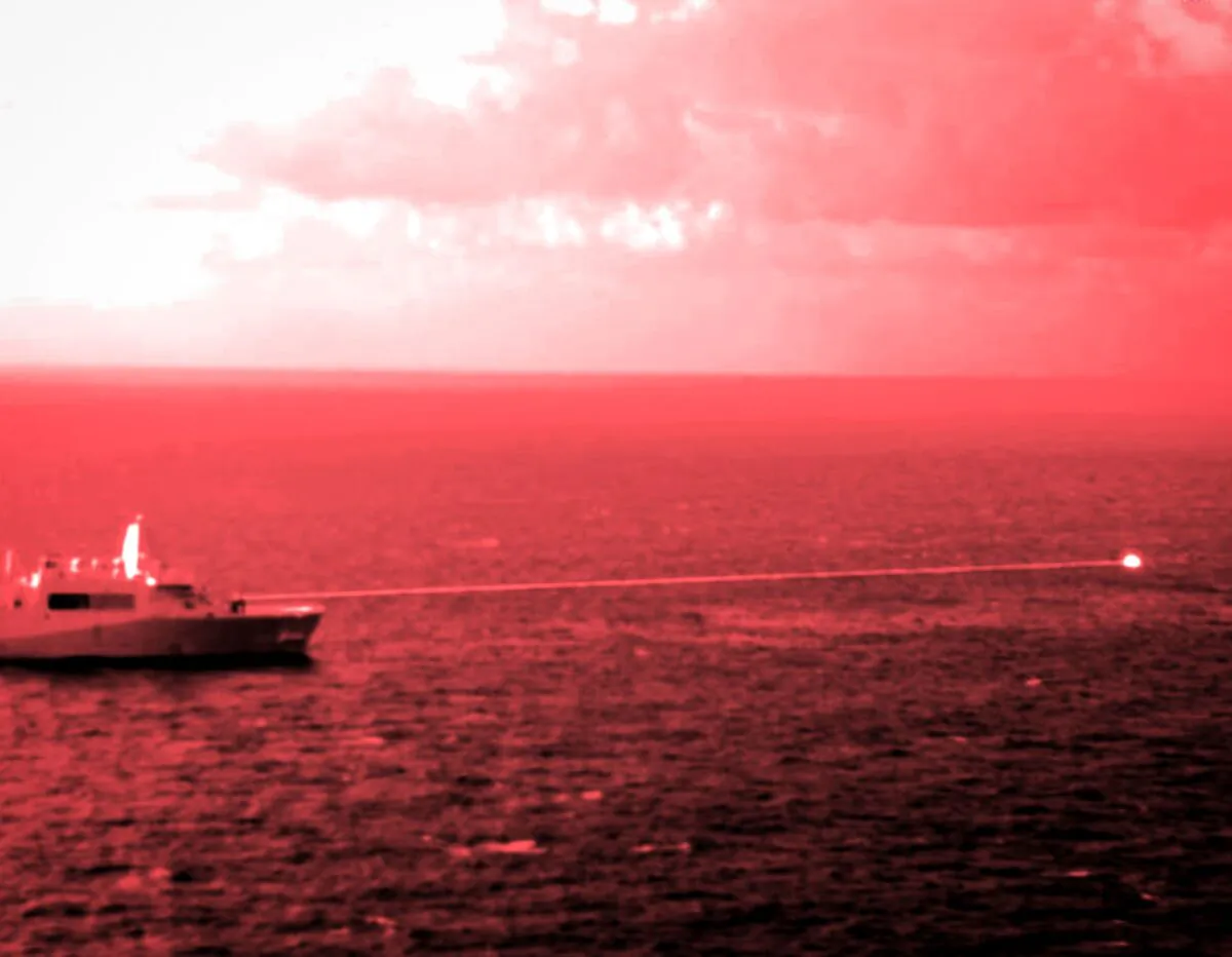 In this handout infrared photo from the U.S. Marine Corps, the 
USS Portland fires a laser weapon system at a target floating in 
the Gulf of Aden, on Tuesday, Dec. 14, 2021. (Staff Sgt. Donald Holbert/U.S. Marine Corps via AP)