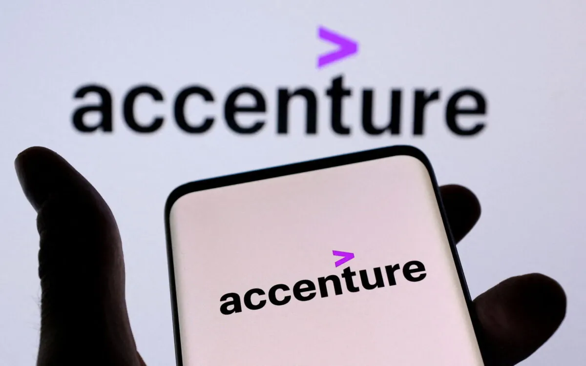 Accenture PLC's logo is seen on a smartphone in front of a displayed same logo in this illustration taken on Dec. 1, 2021. (Dado Ruvic/Illustration/Reuters)