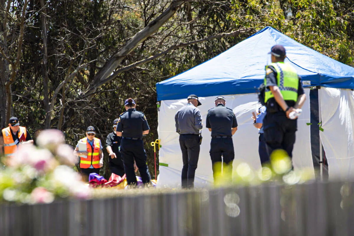 Worksafe Tasmania officers (left) inspect the jumping castle at Hillcrest Primary School in Devonport, Tasmania, Australia, on Dec. 16, 2021. (AAP Image/Grant Wells) 