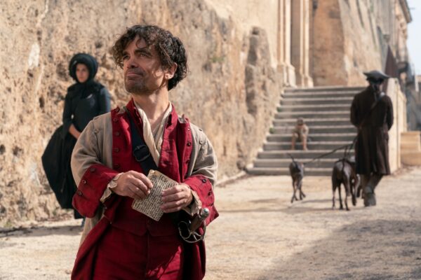 Cyrano (Peter Dinklage) on the street, in “Cyrano.”