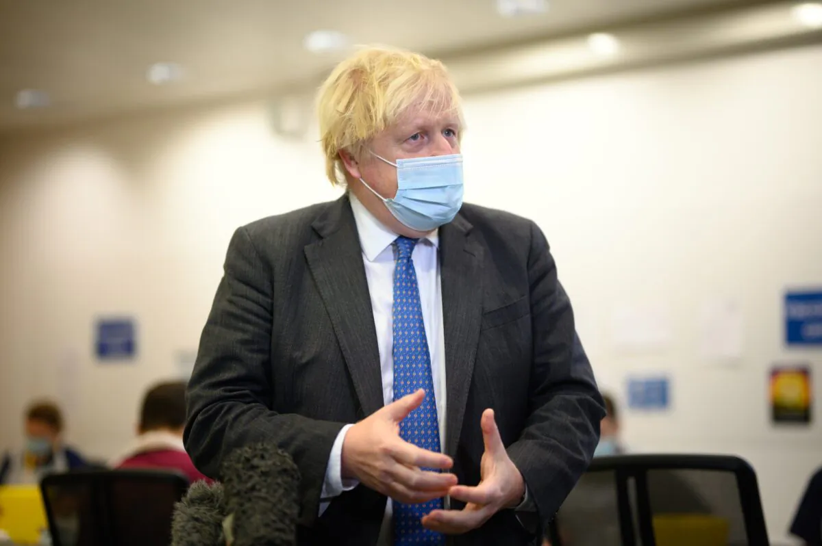 Britain's Prime Minister Boris Johnson speaks with the media during a visit to a COVID-19 vaccination centre near Ramsgate, Kent, England, on Dec. 16, 2021. (Leon Neal - WPA Pool/Getty Images)