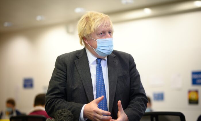 Britain's Prime Minister Boris Johnson speaks with the media during a visit to a COVID-19 vaccination centre near Ramsgate, Kent, England, on Dec. 16, 2021. (Leon Neal - WPA Pool/Getty Images)