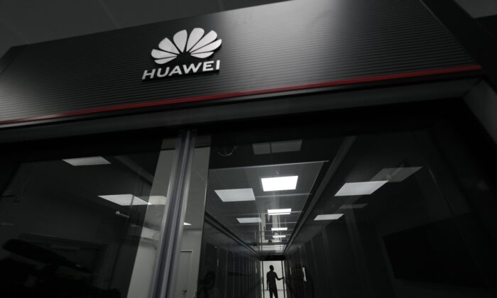 A technician stands at the entrance to a Huawei 5G data centre at the Guangdong Second Provincial General Hospital in Guangzhou, in southern China's Guangdong province, on Sept. 26, 2021. (AP Photo/Ng Han Guan) 