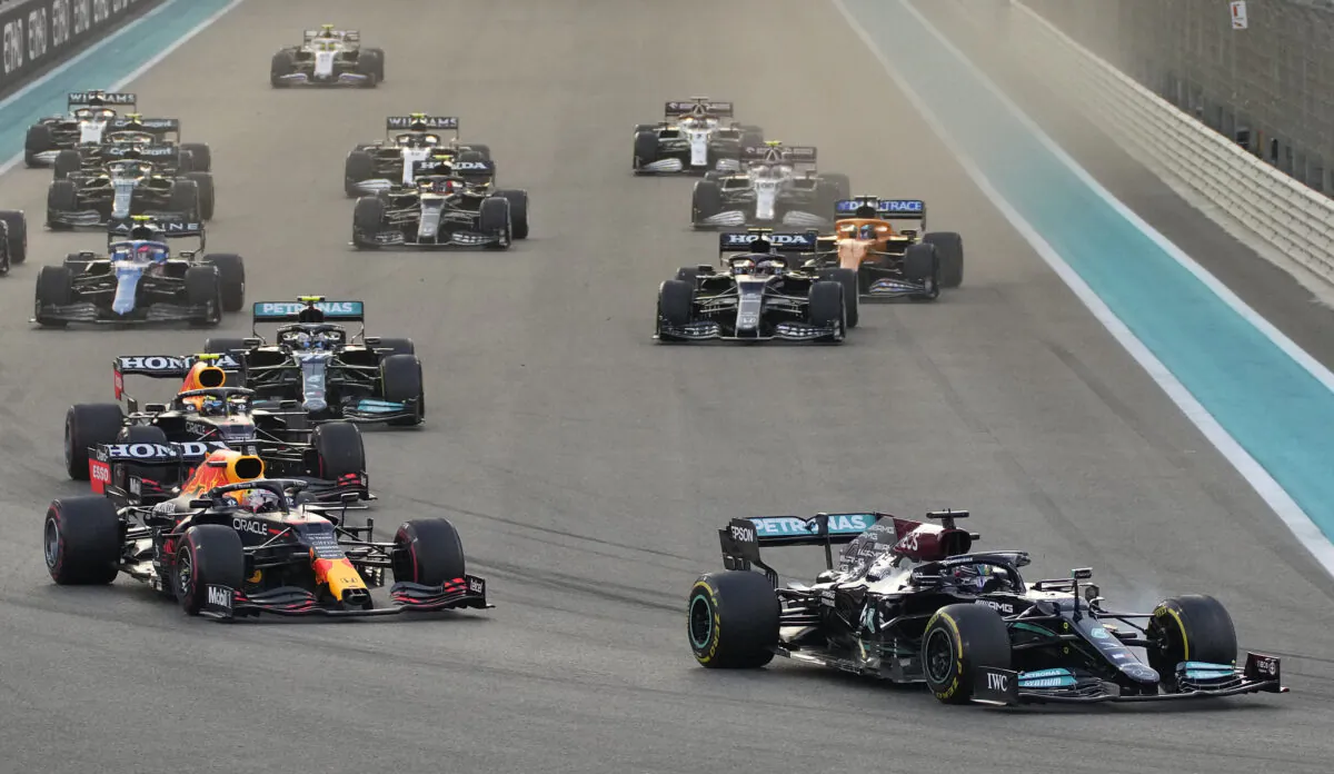 Mercedes driver Lewis Hamilton of Britain in leads Red Bull driver Max Verstappen of the Netherlands at the start of the Formula One Abu Dhabi Grand Prix in Abu Dhabi, United Arab Emirates, on Dec. 12, 2021. (Hassan Ammar/AP Photo)