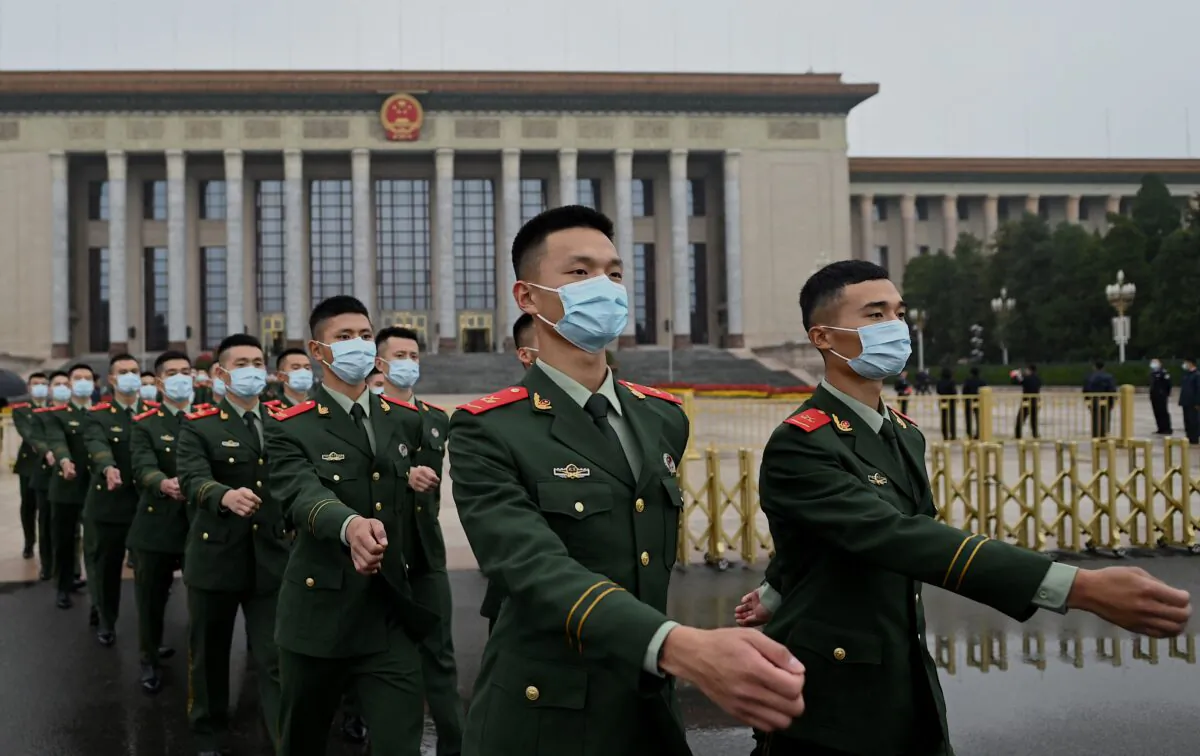 Military delegates march as they leave after the commemoration of the 110th anniversary of the Xinhai Revolution, which overthrew the Qing Dynasty and led to the founding of the Republic of China, at the Great Hall of the People in Beijing on Oct 9, 2021. (Noel Celis/AFP via Getty Images)