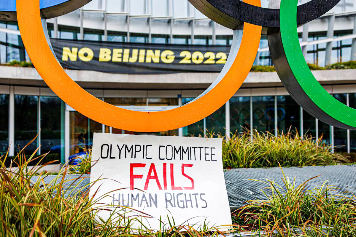 A placard at the entrance of the International Olympic Committee (IOC) headquarters in Lausanne, Switzerland, on Dec. 11, 2021, during a demonstration of Tibetan activists from the Students for a Free Tibet association. (Valentin Flauraud/AFP via Getty Images)
