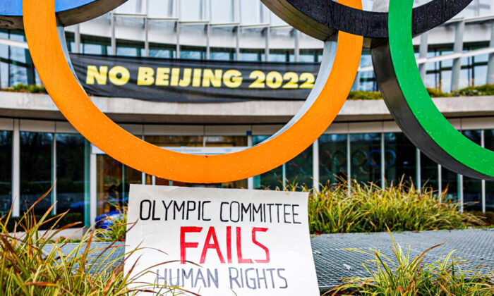 A placard at the entrance of the International Olympic Committee (IOC) headquarters in Lausanne, Switzerland, on Dec. 11, 2021, during a demonstration of Tibetan activists from the Students for a Free Tibet association. (Valentin Flauraud/AFP via Getty Images)