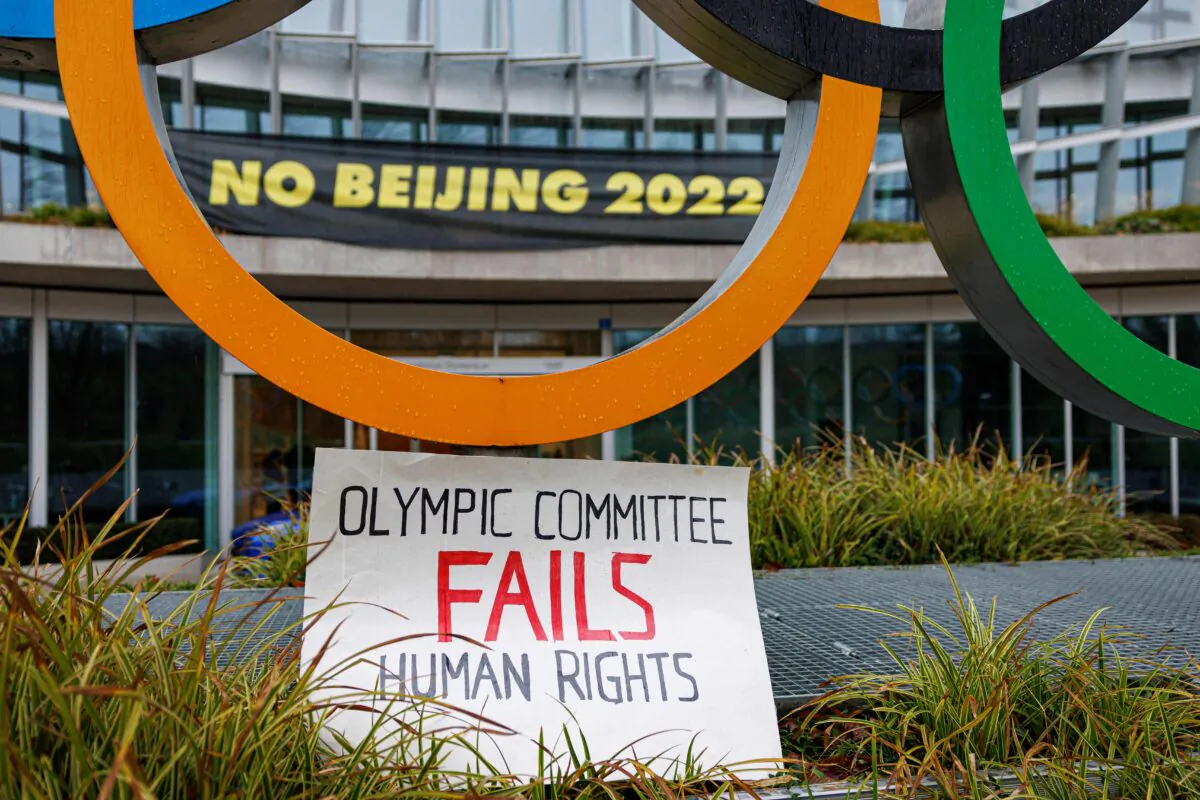 A placard is displayed at the entrance of the International Olympic Committee (IOC) headquarters during a demonstration of Tibetan activists from the Students for a Free Tibet association, in Lausanne, Switzerland, on Dec. 11, 2021. (Valentin Flauraud/AFP via Getty Images)