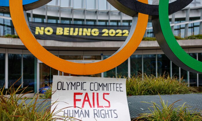 A placard is displayed at the entrance of the International Olympic Committee (IOC) headquarters during a demonstration of Tibetan activists from the Students for a Free Tibet association, in Lausanne, Switzerland, on Dec. 11, 2021. (Valentin Flauraud/AFP via Getty Images)