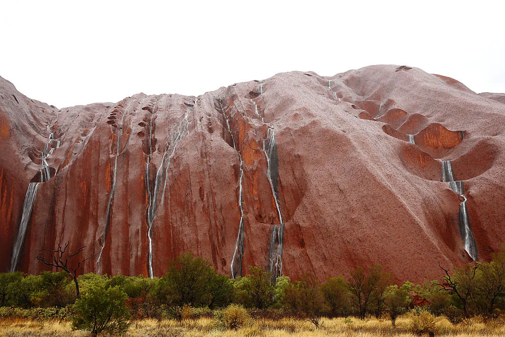 A general view of Uluru is seen as it rains on November 28, 2013 in Uluru-Kata Tjuta National Park, Australia. (Photo by Mark Kolbe/Getty Images)