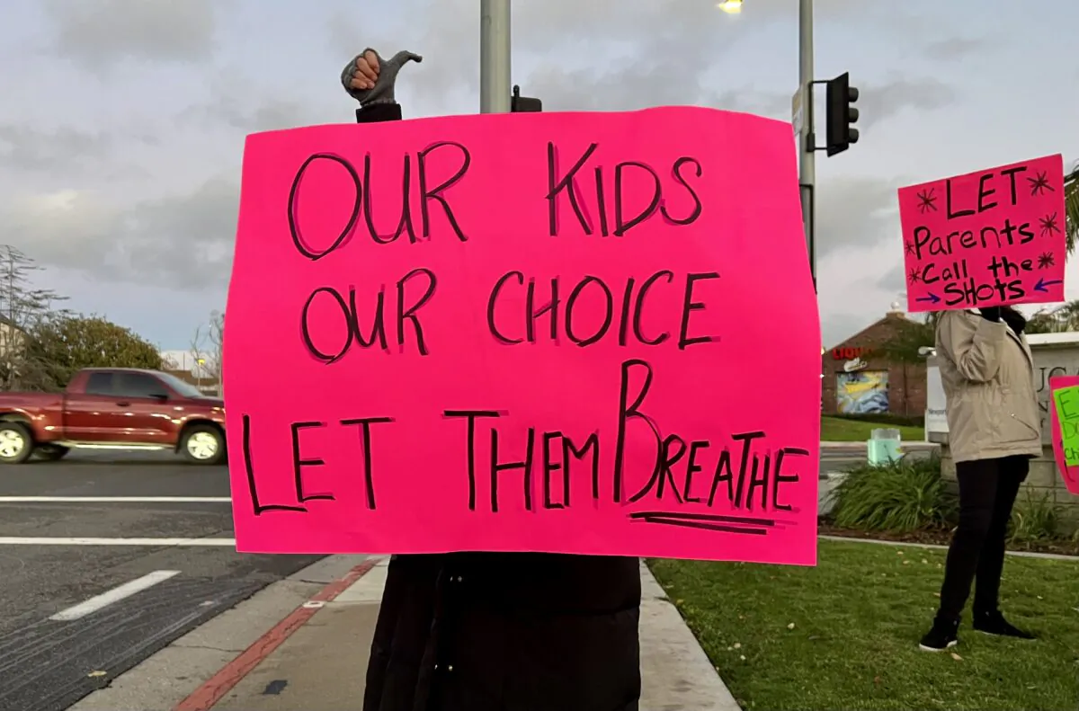 Parents, teachers, and other concerned citizens gather in front of the Newport-Mesa Unified School District in Costa Mesa, Calif., on Dec. 14, 2021. (Drew Van Voorhis/The Epoch Times)