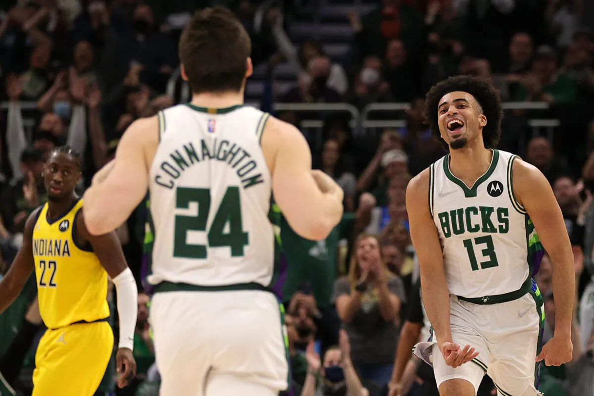 Jordan Nwora #13 of the Milwaukee Bucks reacts to a three point shot by Pat Connaughton #24 during the second half of a game against the Indiana Pacers at Fiserv Forum in Milwaukee, WI on Dec. 15, 2021. (Stacy Revere/Getty Images)
