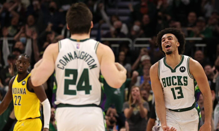 Jordan Nwora #13 of the Milwaukee Bucks reacts to a three point shot by Pat Connaughton #24 during the second half of a game against the Indiana Pacers at Fiserv Forum in Milwaukee, WI on Dec. 15, 2021. (Stacy Revere/Getty Images)
