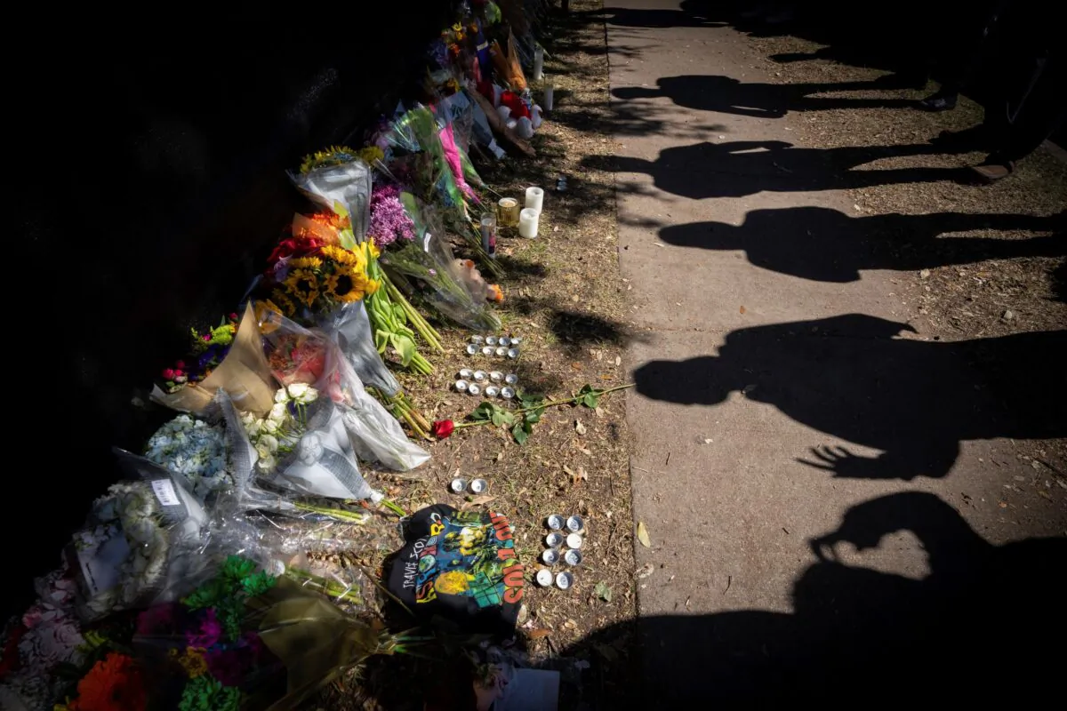 Visitors cast shadows at a memorial to the victims of the Astroworld concert in Houston on Nov. 7, 2021. (Robert Bumsted/AP Photo)