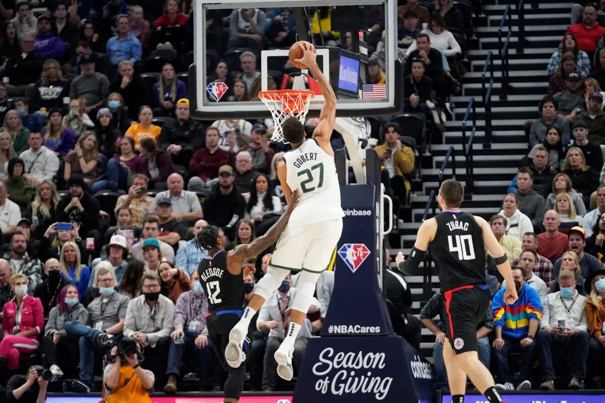 Utah Jazz center Rudy Gobert (27) dunks on Los Angeles Clippers guard Eric Bledsoe (12) in the second half during an NBA basketball game in Salt Lake City, on Dec. 15, 2021. (Rick Bowmer/AP Photo)