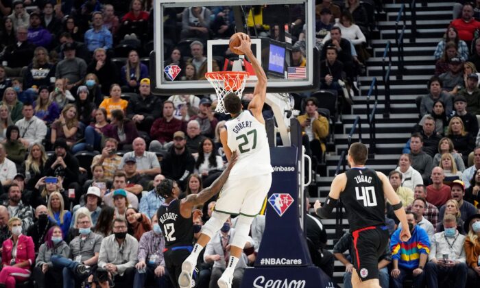 Utah Jazz center Rudy Gobert (27) dunks on Los Angeles Clippers guard Eric Bledsoe (12) in the second half during an NBA basketball game in Salt Lake City, on Dec. 15, 2021. (Rick Bowmer/AP Photo)