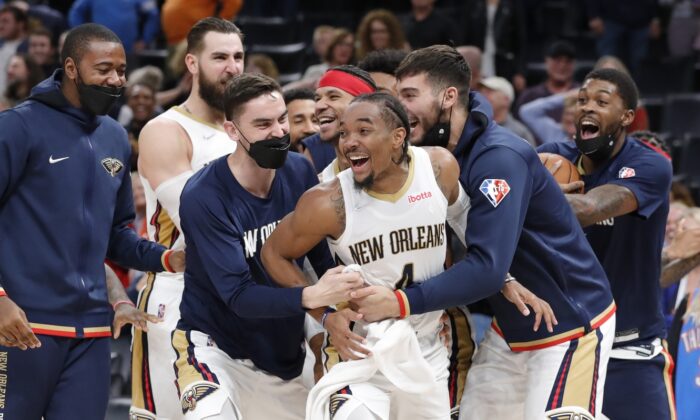 New Orleans Pelicans guard Devonte' Graham (4) celebrates with his team during an NBA game at Paycom Center, in Oklahoma City, O.K., on Dec. 15, 2021. (Alonzo Adams/USA TODAY Sports via Field Level Media)