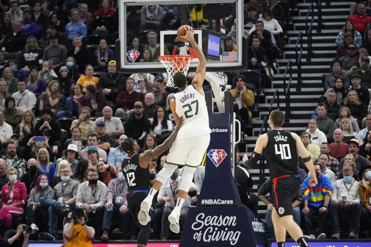 Utah Jazz center Rudy Gobert (27) dunks on Los Angeles Clippers guard Eric Bledsoe (12) during an NBA game in Salt Lake City, on Dec. 15, 2021. (Rick Bowmer/AP Photo)