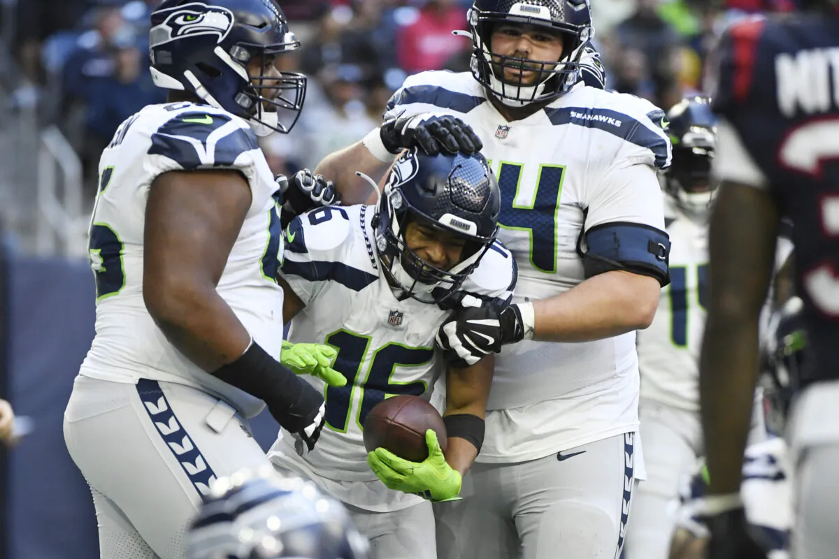 Seattle Seahawks wide receiver Tyler Lockett (16) celebrates with teammates after catching a pall for a two-point conversion against the Houston Texans during the second half of an NFL football game in Houston, on Dec. 12, 2021. (Justin Rex/AP Photo)