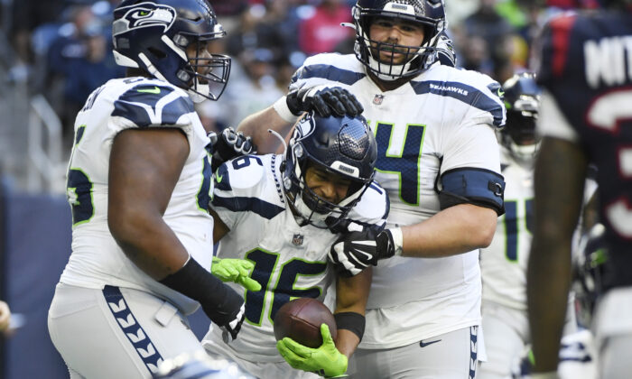 Seattle Seahawks wide receiver Tyler Lockett (16) celebrates with teammates after catching a pall for a two-point conversion against the Houston Texans during the second half of an NFL football game in Houston, on Dec. 12, 2021. (Justin Rex/AP Photo)