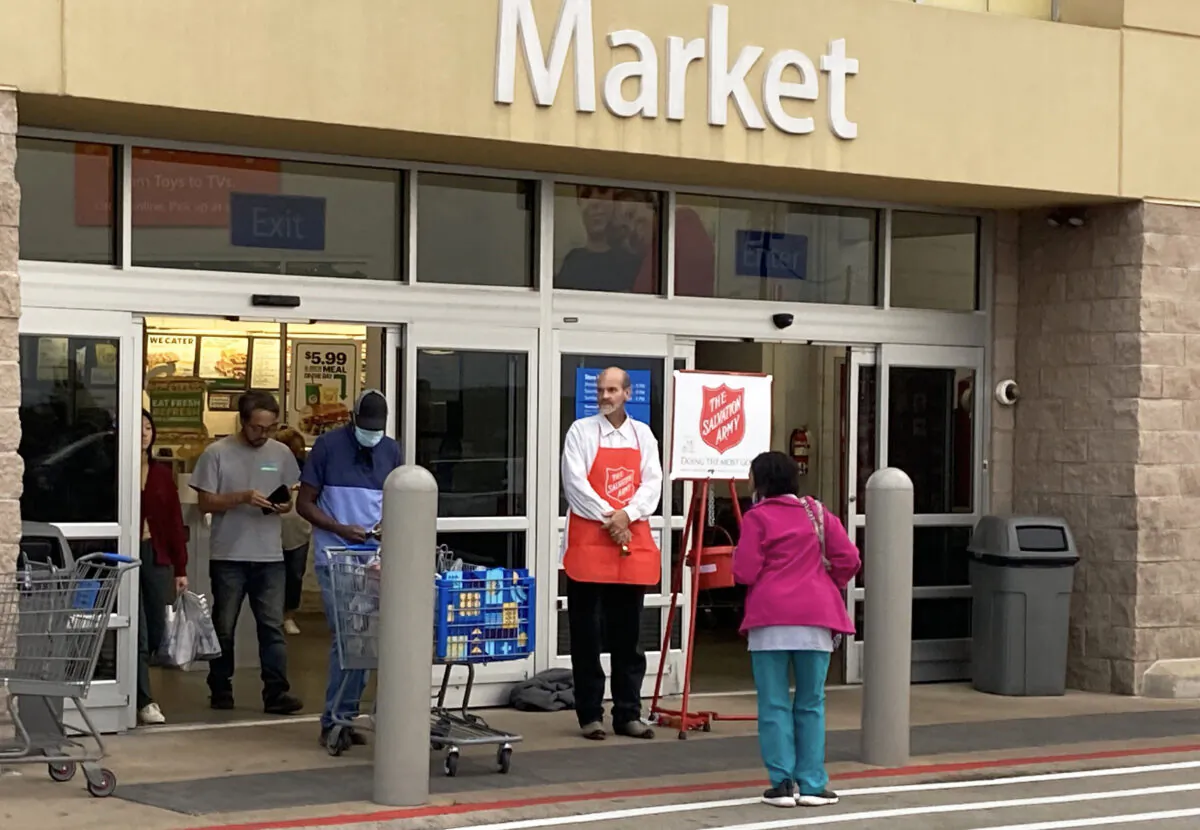 Jeffrey Gordon rings Red Kettle Christmas bells to passersby at a Wal-Mart store in Lindale, East Texas, population cir 4,000, Dec. 14, 2021. (Patrick Butler/The Epoch Times)