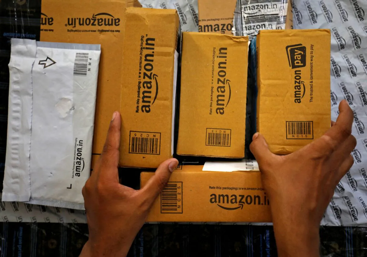 A worker sorts delivery packages in a van, outside an Amazon facility in Ahmedabad, India, on March 17, 2021. (Amit Dave/Reuters)