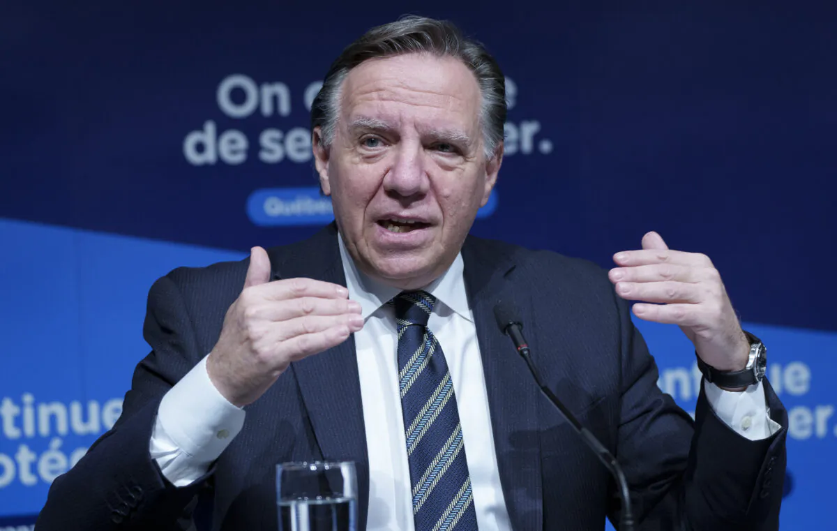 Quebec Premier Francois Legault gestures during a news conference in Montreal, on Dec. 16, 2021. (Paul Chiasson/The Canadian Press)