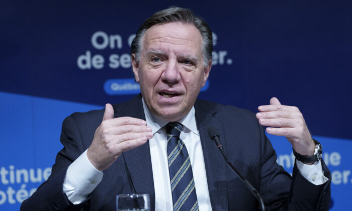 Quebec Premier Francois Legault gestures during a news conference in Montreal, on Dec. 16, 2021. (Paul Chiasson/The Canadian Press)