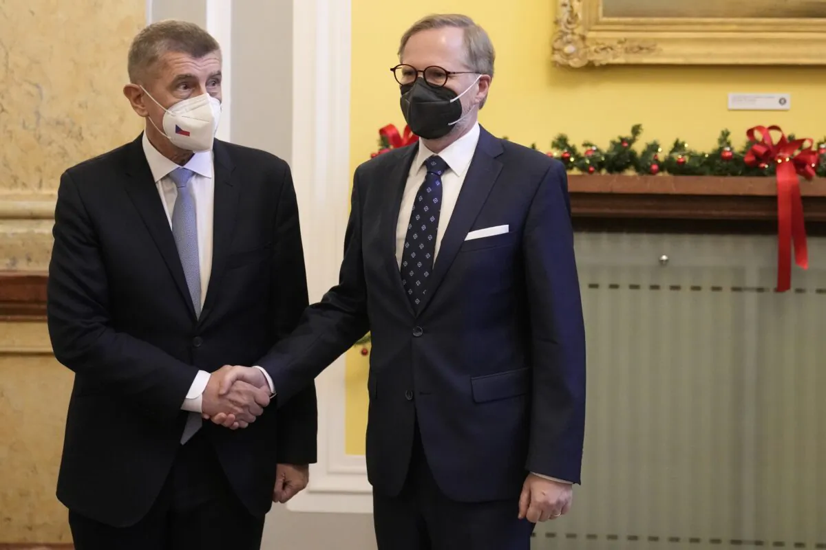 Czech Republic's outgoing Prime Minister Andrej Babis (L) shake hands with newly appointed Prime Minister Petr Fiala at the government headquarters in Prague, Czech Republic, on Dec. 17, 2021. (Petr David Josek/AP Photo)