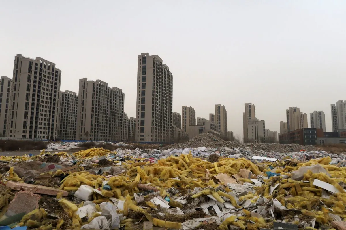 Debris is seen in front of the apartment compound Taoyuan Xindu Kongquecheng, developed by China Fortune Land Development, in Zhuozhou, Hebei Province, China, on March 19, 2021. (Lusha Zhang/Reuters)